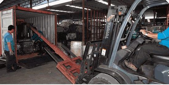 Engines being loaded into a shipping container for export